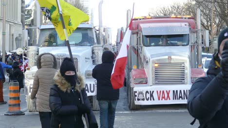 A-group-of-people-holding-protests-signs-at-the-Freedom-Convoy-protest-in-Ottawa,-Canada