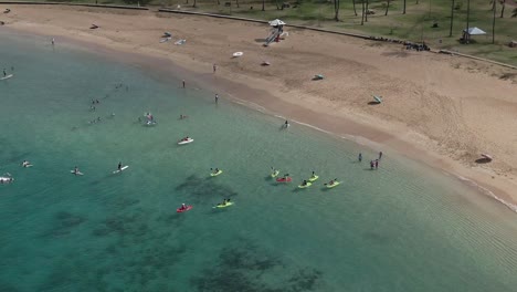 Aerial-view-of-students-learning-to-kayak-at-Magic-Island-cove