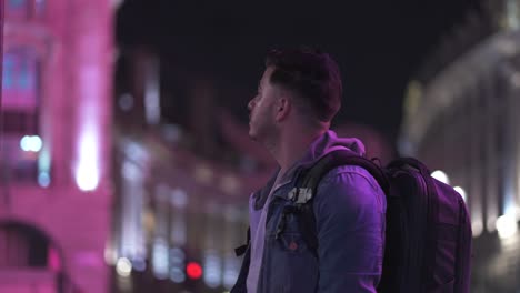 Low-Light-Portrait-Shot-of-Man-Looking-at-London-Sights-with-Bus-Passing-By