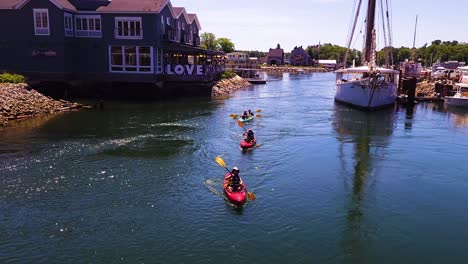 Kayakers-going-past-a-large-sailboat-in-Kennebunkport-Harbor