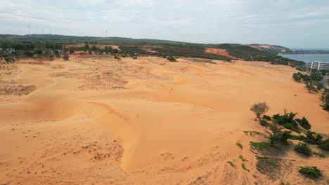 Picture/Photo: Woman on top of red sand dunes. Mui Ne, Vietnam