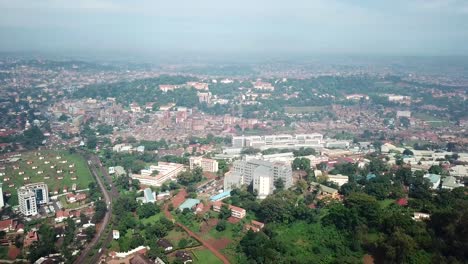 Cityscape-of-Kempala,-largest-city-and-the-capital-of-Uganda,-during-sunny-day---birds-eye-view