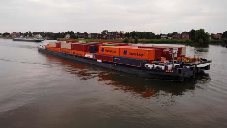 Aerial-Starboard-View-Of-Maas-Inland-Push-Tow-Cargo-Container-Vessel-Going-Past-On-River-Noord
