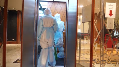 Asian-Nurse-Wear-PPE-Carry-Oxygen-Tank-Inside-Quarantine-Building