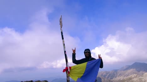 Man-looking-into-camera-holding-Romanian-flag-and-waving