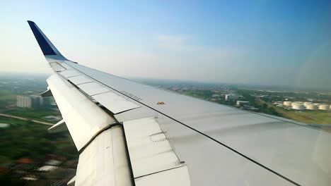airplane-landing-view-from-cabin-flight-windows,-plane-landing-at-soekarno-hatta-international-airport-CGK,-Indonesia-6°07'05