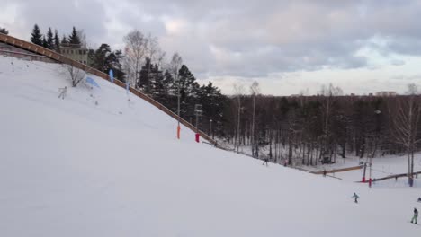 Ski-slopes-of-Tallinn-in-mustamäe-district-with-moody-sky-and-people-skiing