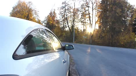 Car-in-woodland-with-sunset-peaking