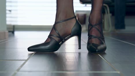showing-elegant-stiletto-high-heels-in-front-of-the-camera-placed-on-the-floor