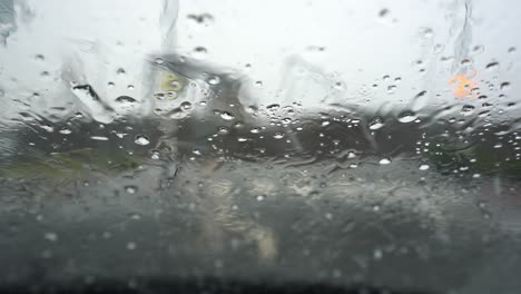 Heavy-rain,-hale,-hail-on-the-windscreen-making-visibility-poor-and-driving-conditions-dangerous-and-un-predictable