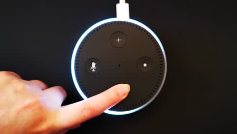Girl-pressing-the-volume-down-button-on-the-Alexa-artificial-intelligence-device
