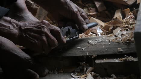 Close-up-on-an-old-Muslim-man-working-wood-in-the-Traditional-Sundanese-village-Kampung-naga