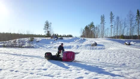 Aerial,-senior-man-driving-snowmobile,-roll-over-in-snow,-lovely-winter-weather