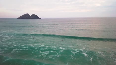 A-surfer-attempts-to-catch-a-wave.-Drone-shot