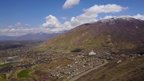 Drone-Shot-high-above-Draper-City,-Utah-flying-towards-the-Mormon-Draper-Temple