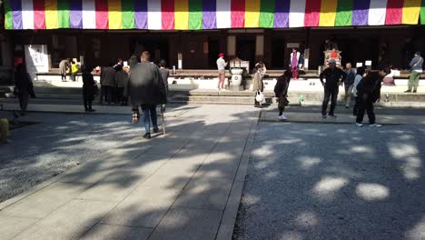 Tilt-up-as-tourists-and-pilgrims-enter-main-colorful-exterior-of-Eigenji-Temple