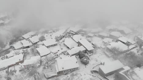 Aerial-footage-over-snowy-mountain,-traditional-village-in-Greece-10