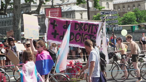 People-at-the-Gay-Pride-2019-in-Paris-marching-alongside-bikes-with-signs-for-human-rights