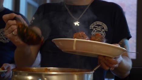 Firefighters-serve-spaghetti-and-meatballs-at-a-fire-station-dinner