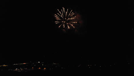 Aerial-of-Fireworks-Over-Small-Town-With-Moon