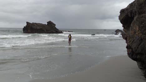 Bikini-model-dancing-and-taking-selfies-at-the-shoreline-at-this-amazing-beach