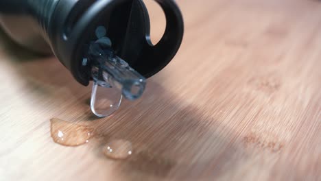 Metal-Water-Bottle-Rotating-on-a-Wooden-Surface-with-Water-Droplets