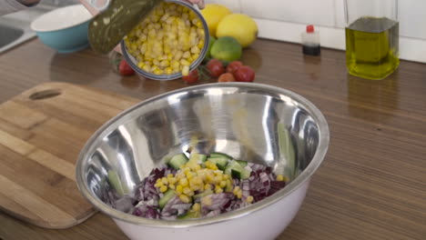 Slow-motion-as-pouring-boiled-corn-in-a-salad-from-a-tin-can