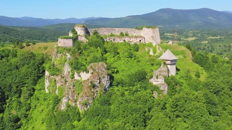 Aerial-Dolly-Back-View-Of-Ostrovica-Castle-With-Overgrown-Trees