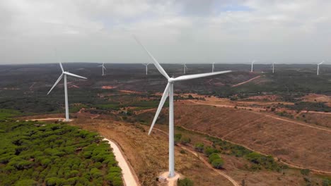 Aerial-shot-of-a-wind-farm-in-Barao-de-Sao-Joao,-Portugal-level-with-the-top-of-the-turbines