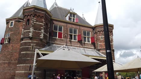 Waag-building-near-Nieuwmarkt,-and-traditionally-a-trade-centre-in-Amsterdam,-Holland,-Netherlands,-Europe