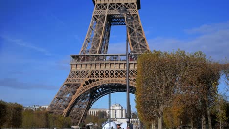Nov-2019,-Paris,-France:-tourists-walking-in-front-of-the-Tour-Eiffel-in-a-sunny-autumn-day