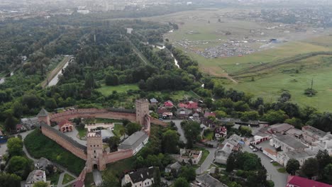 Aerial-View-of-Music-Festival-in-Distance-With-Small-European-Town-in-Foreground