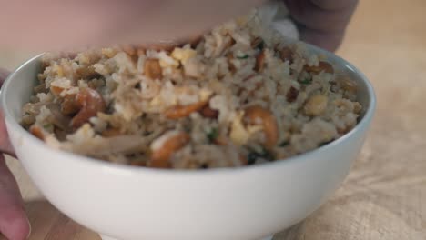 Close-Slider-Shot-of-Cleaning-the-Sides-of-a-White-Bowl-of-Fried-Rice