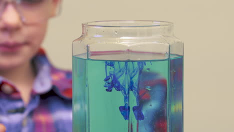 A-little-boy-doing-a-science-experiment-by-mixing-colors