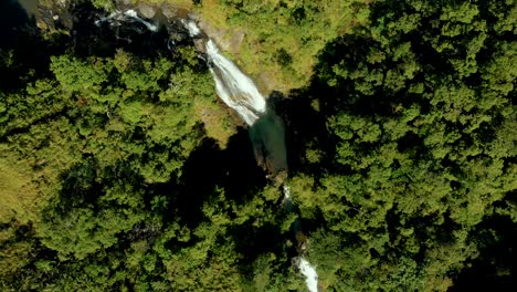 Aerial,-top-view-revealing-isolated-waterfalls-on-wood-land-area