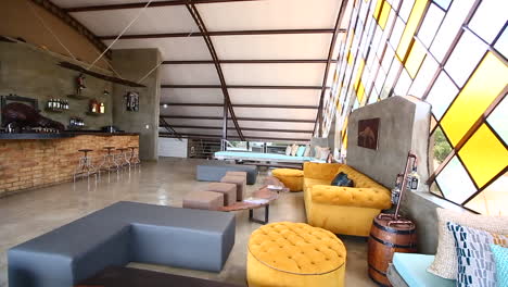 Second-floor-lounge-in-the-beautiful-Pangolin-Chobe-Hotel,-pan-right