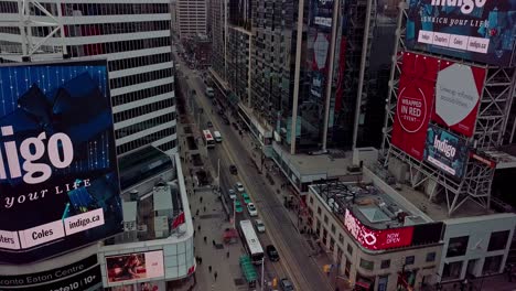 Car-and-Bus-Traffic-on-Busy-City-Street,-Wide-Drone-Tilt-Down-Dolly