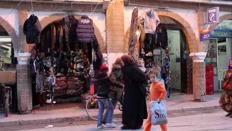 Vista-De-La-Calle-De-Hombres-Y-Mujeres-Locales-Comprando-En-Essaouira,-Marruecos-Durante-El-Día