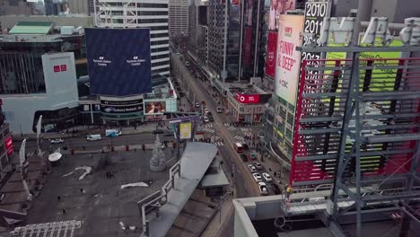 Establishing-Aerial-of-Big-City-Downtown-and-Huge-Ad-Screens-for-Shops