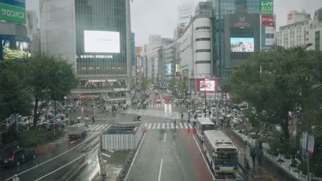 Scene-On-Busiest-Road-And-Cityscape-During-Rainy-Day-In-Shibuya-Crossing,-Tokyo-Japan