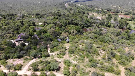 Aerial-view-of-a-Nature-Reserve-near-Kruger-Park,-with-a-lodge-in-an-arid-bush-landscape