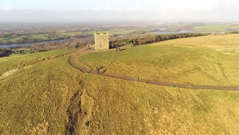 Fell-runners-gathered-on-Rivington-tower-Lancashire-reservoir-countryside-aerial-descending-view