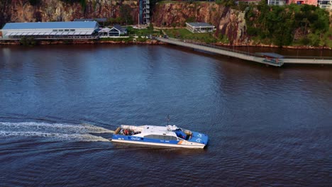 CityCat-Cruising-At-Brisbane-River-With-Jet-Skier-Speeding-On-Water-In-Brisbane-City,-Queensland,-Australia