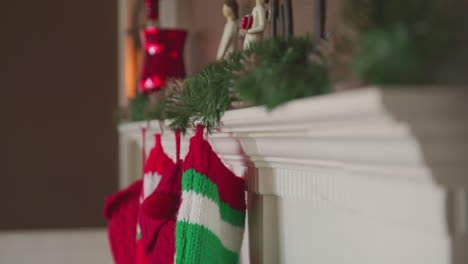 Christmas-stockings-hang-from-a-decorated-mantel