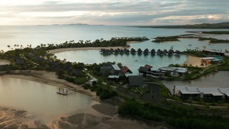Famous-Marriot-resort-with-luxury-overwater-bungalows-in-exotic-lagoon,-aerial