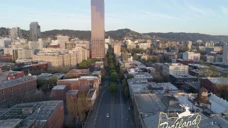 Wide-and-majestic-aerial-shot-revealing-Portland,-Oregon's-iconic-Old-Town-sign-with-empty-streets-due-to-COVID-19