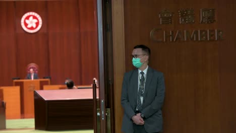 A-Security-guards-stand-at-the-entrance-of-the-Chamber-during-the-third-reading-of-debate-ahead-of-the-vote-on-the-Chinese-national-anthem