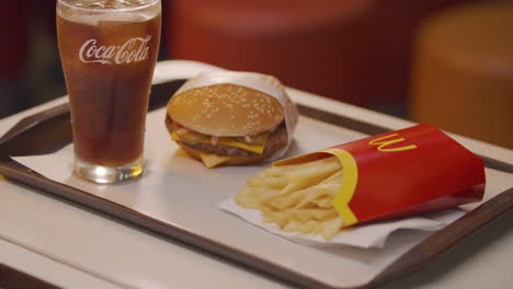 Slow-Motion-Tilt-Up-Shot-Of-Coke,-Mcdonald's-Burger-And-Fries