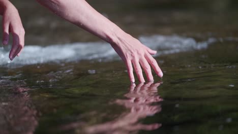 Hand-moving-over-water