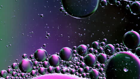 Mixing-Bubble-of-Water-and-Oil,-Colored-in-Pink-Purple-and-Green,-Abstract-Background